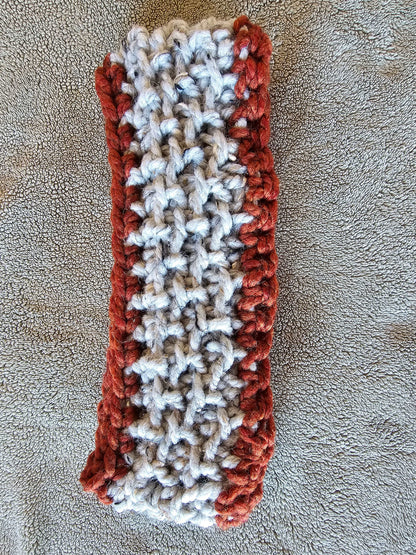 Chunky crochet headband in deep red and gray tweed. Wool acrylic blend for easy care. Adult size. Shown flat for color and texture detail..