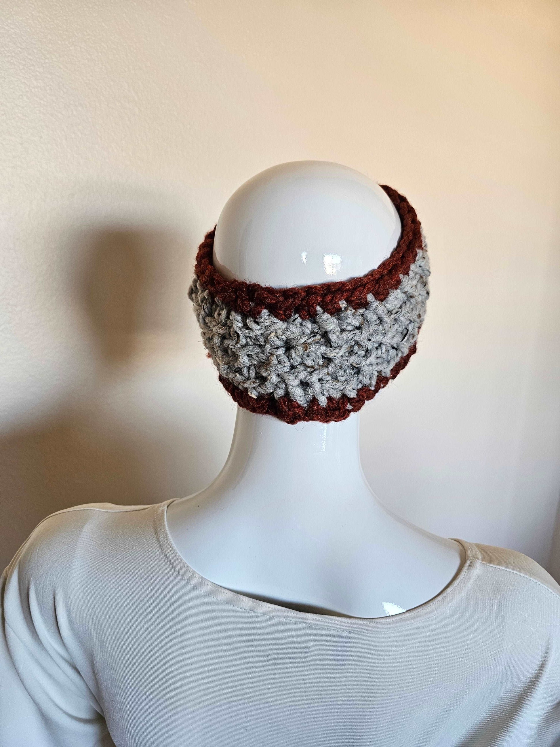 Chunky crochet headband in deep red and gray tweed. Wool acrylic blend for easy care. Adult size. Shown from back on mannequin.